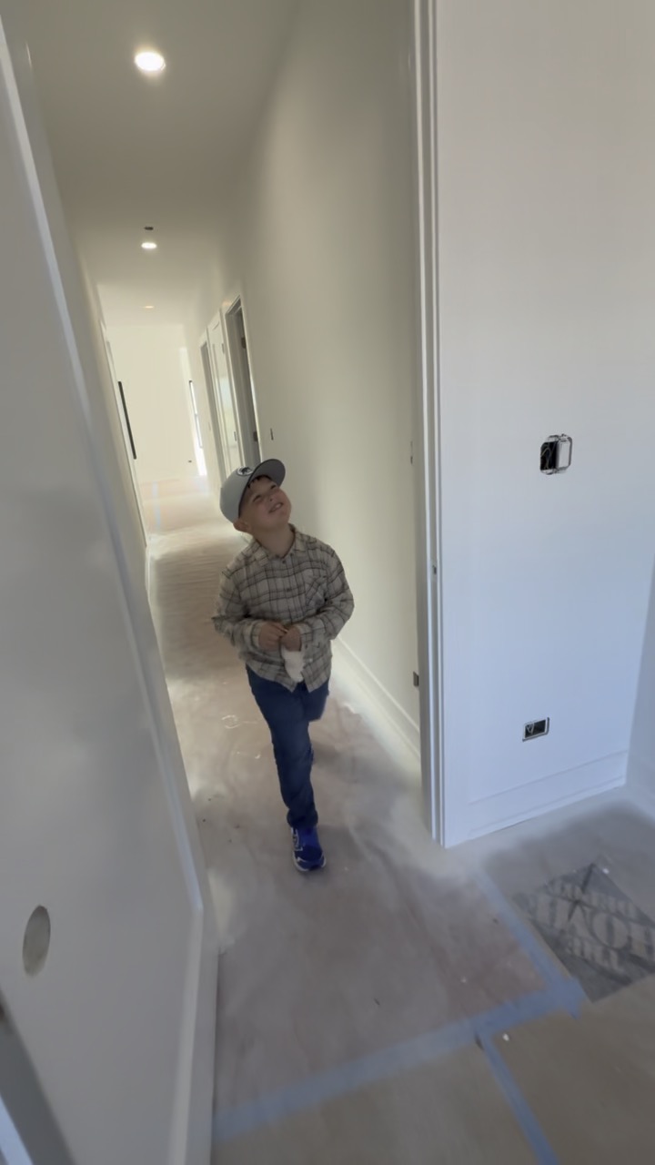 Mason looking up as he walks through a home under construction.